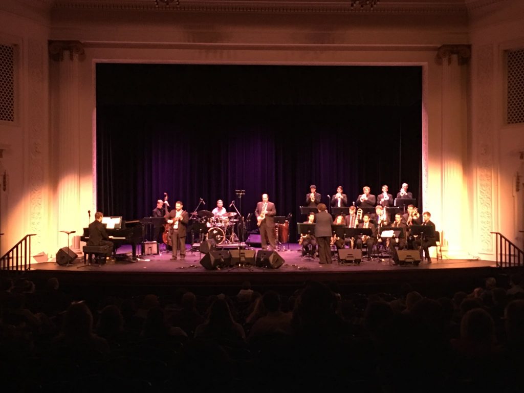 an orchestra plays on the stage