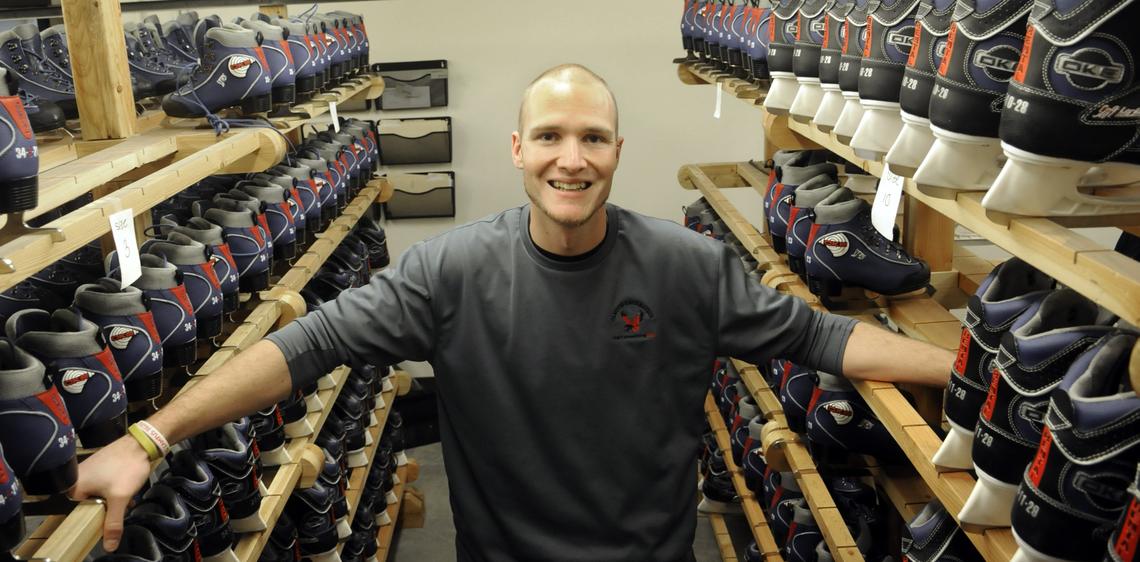 the rental skates employee poses with skates