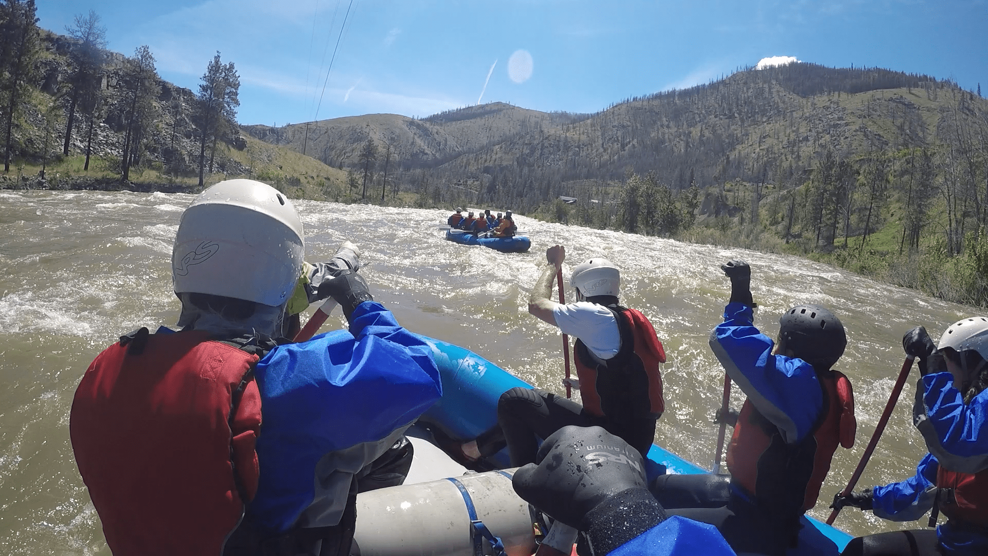 River boaters, rowing down a river