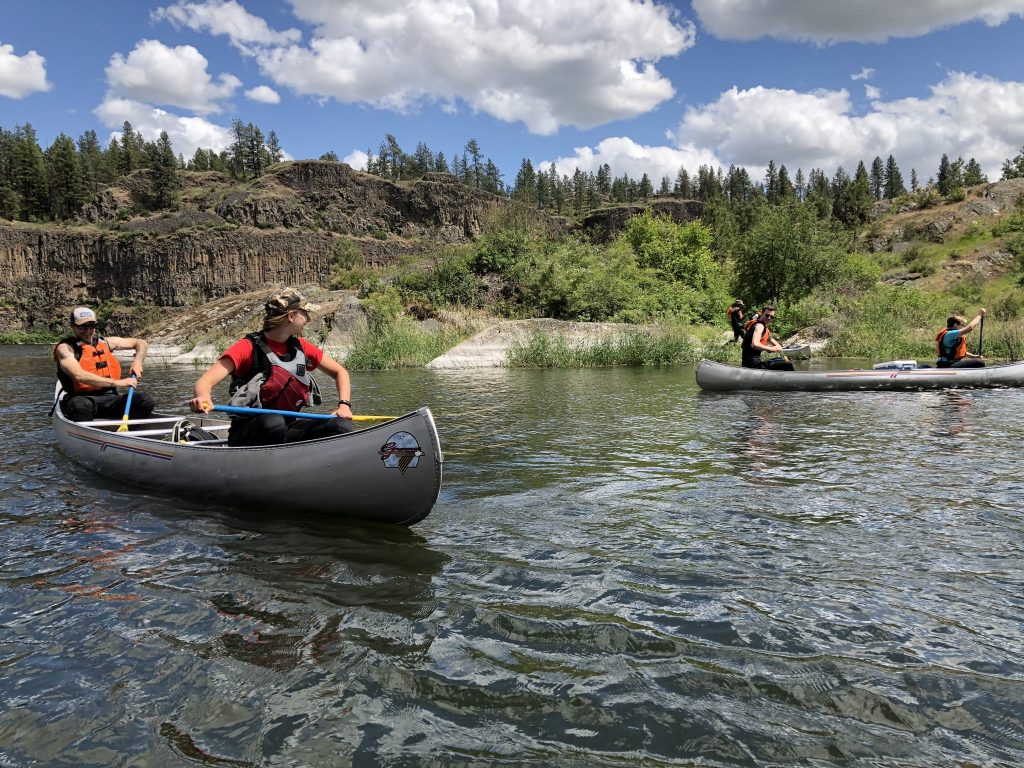 Kayakers kayaking down a river