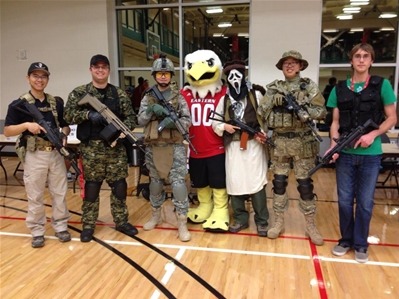 Airsoft team holding airsoft rifles next to swoop