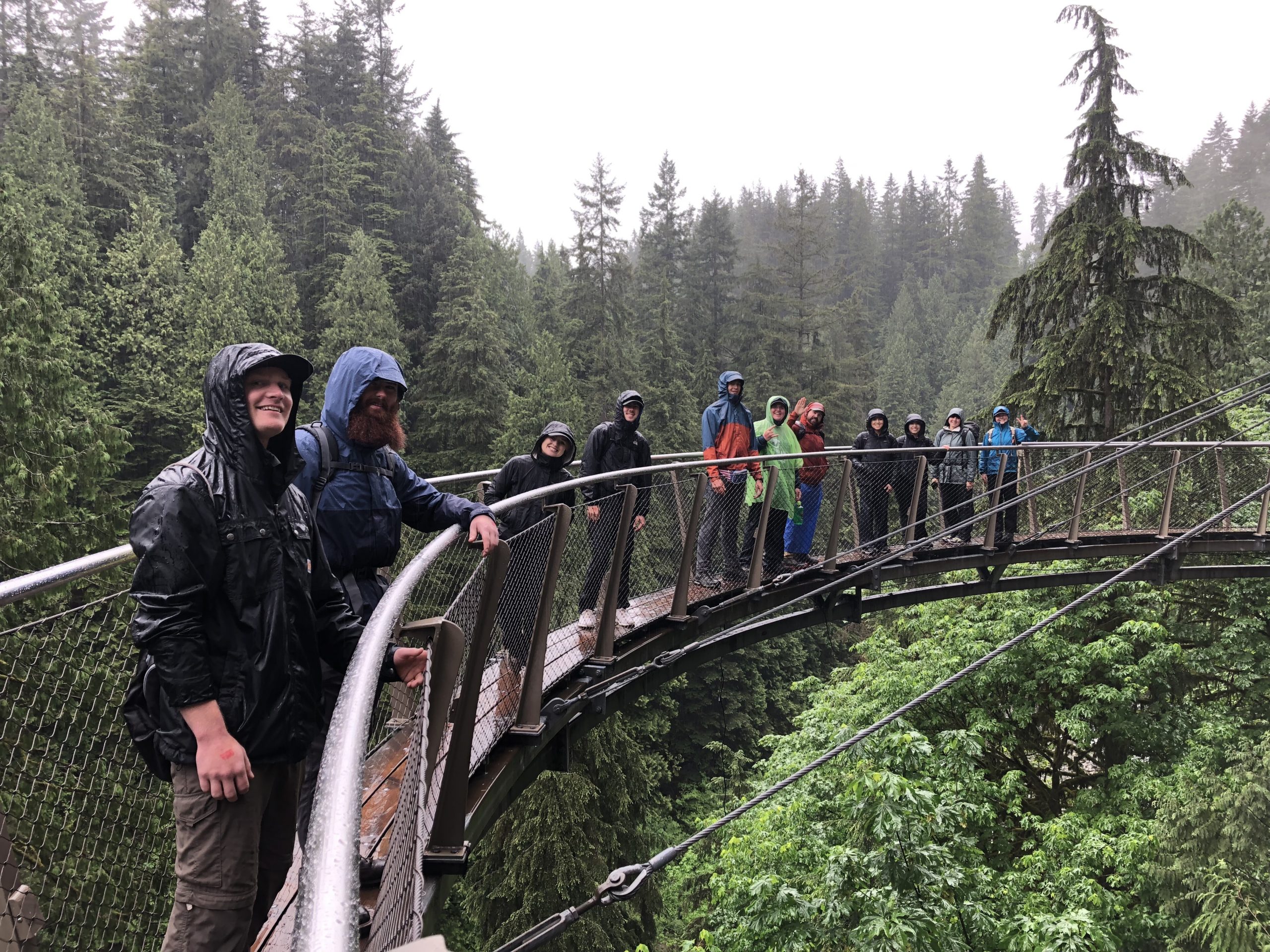 Hikers on a narrow tall bridge