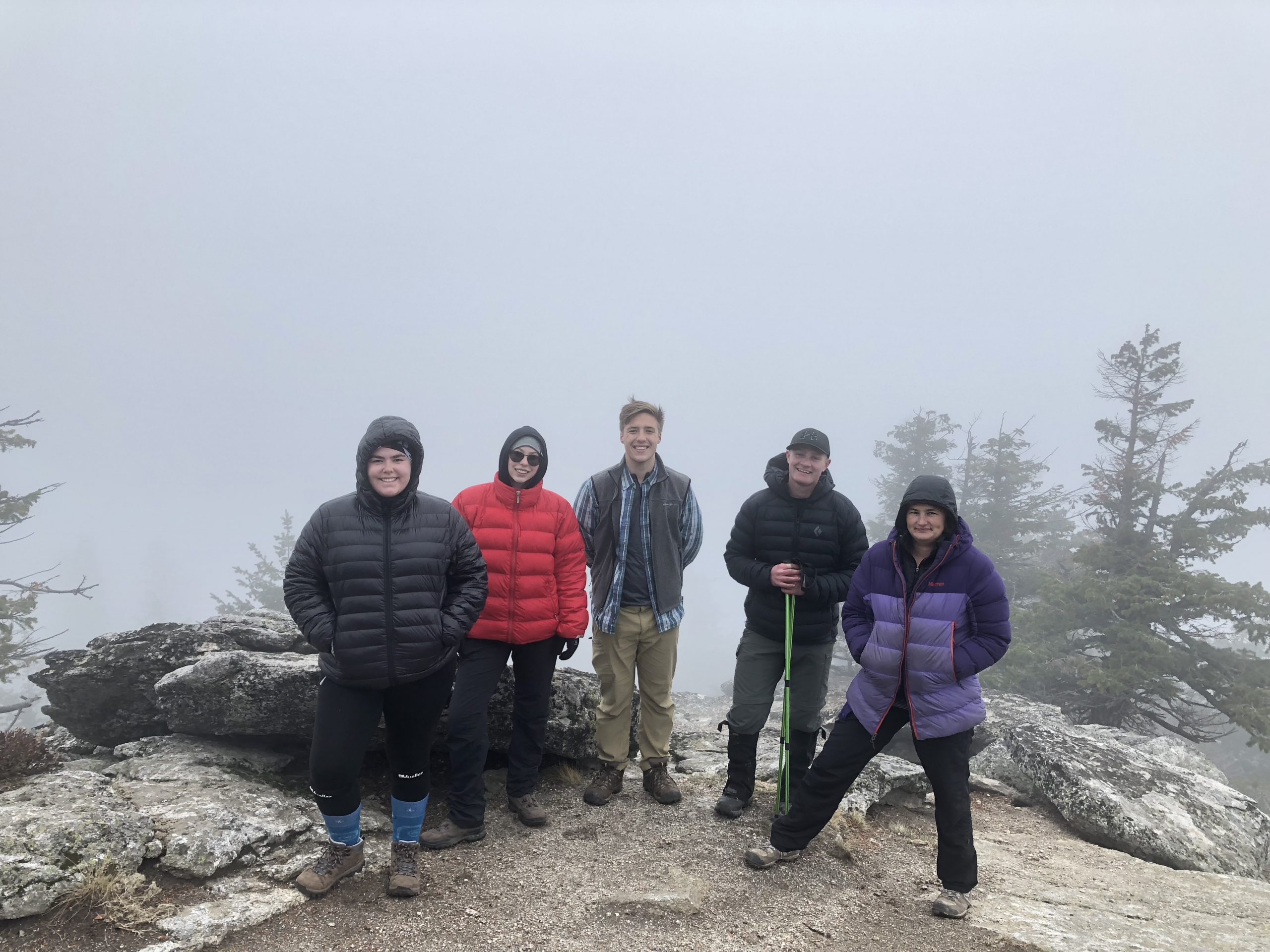 Group of staff standing on a cliff ledge