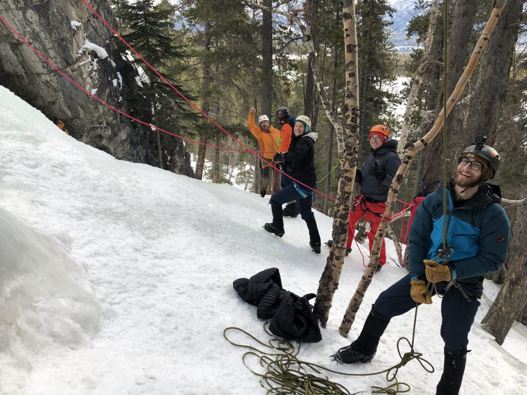 Three people hiking in a snowy forest