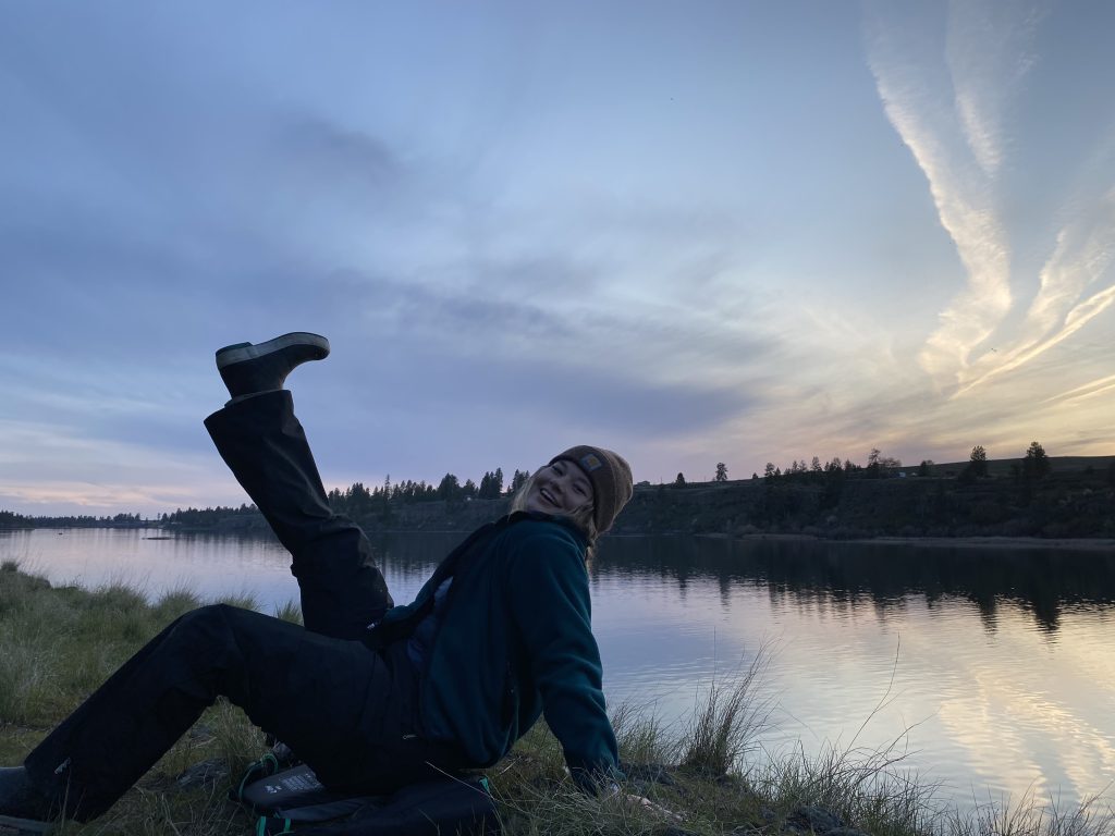 Mya D. - Trip Specialist kicking her feet up at sunset