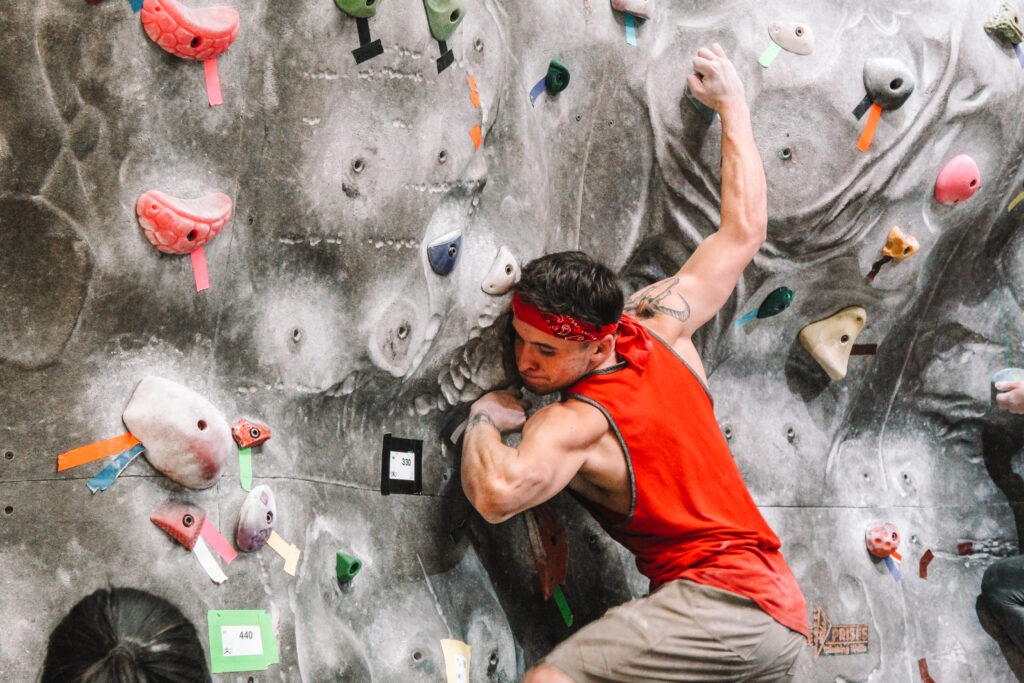 Man scaling a climbing rockwall