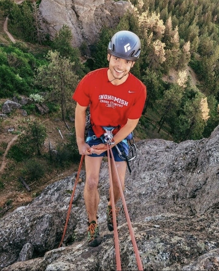 Joel L. - Field Staff, scaling a cliff