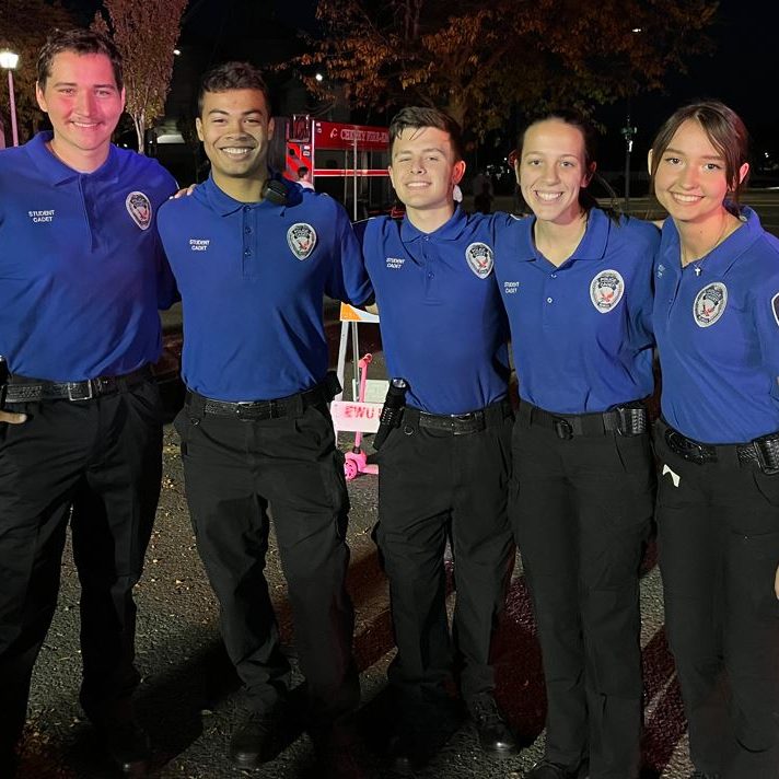 EWU Cadets wearing their uniforms standing together smiling