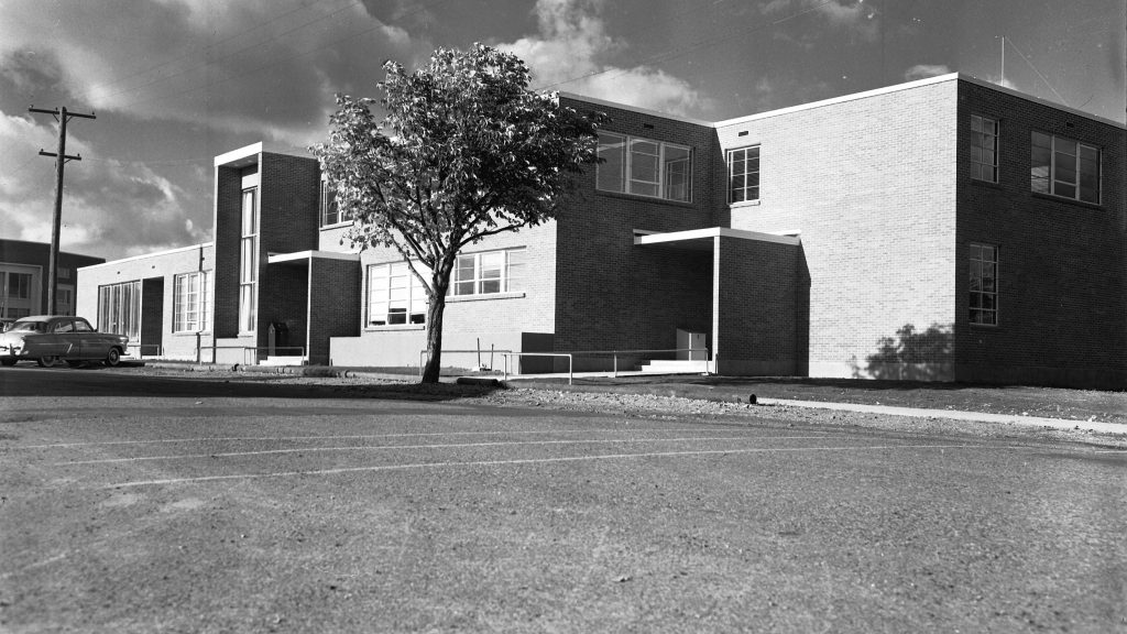 Photo of old Isle Hall. It's view is from the front at angle. The photo is in black and white.