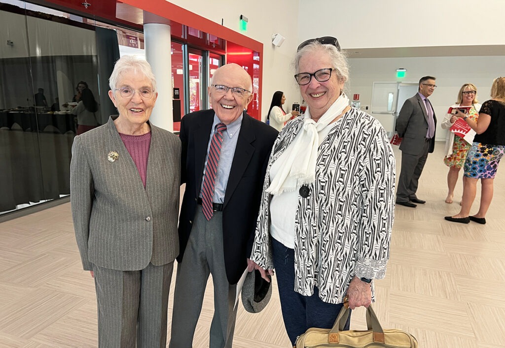 Three people standing together for a photo