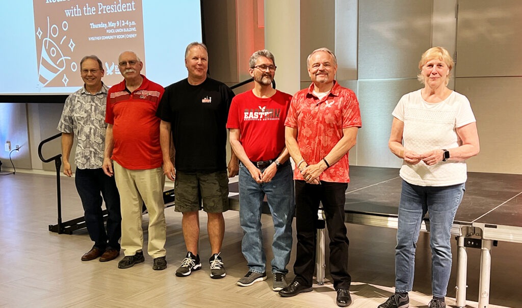 A group photo of people in front of a stage