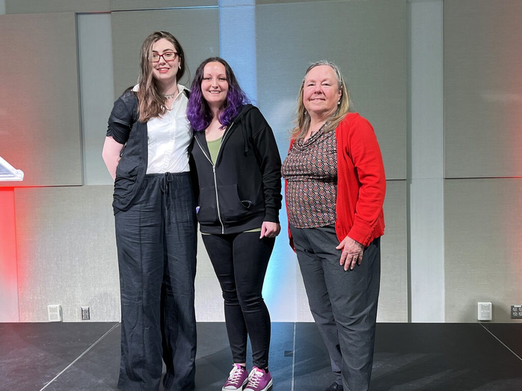Three people standing on a stage for. photo