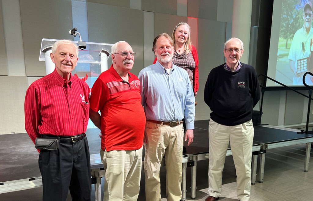 A group of people standing in front of a stafe