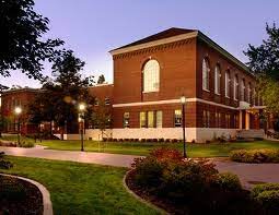 A photo of Hargreaves Hall. The building is made with red bricks and surrounded by grass.