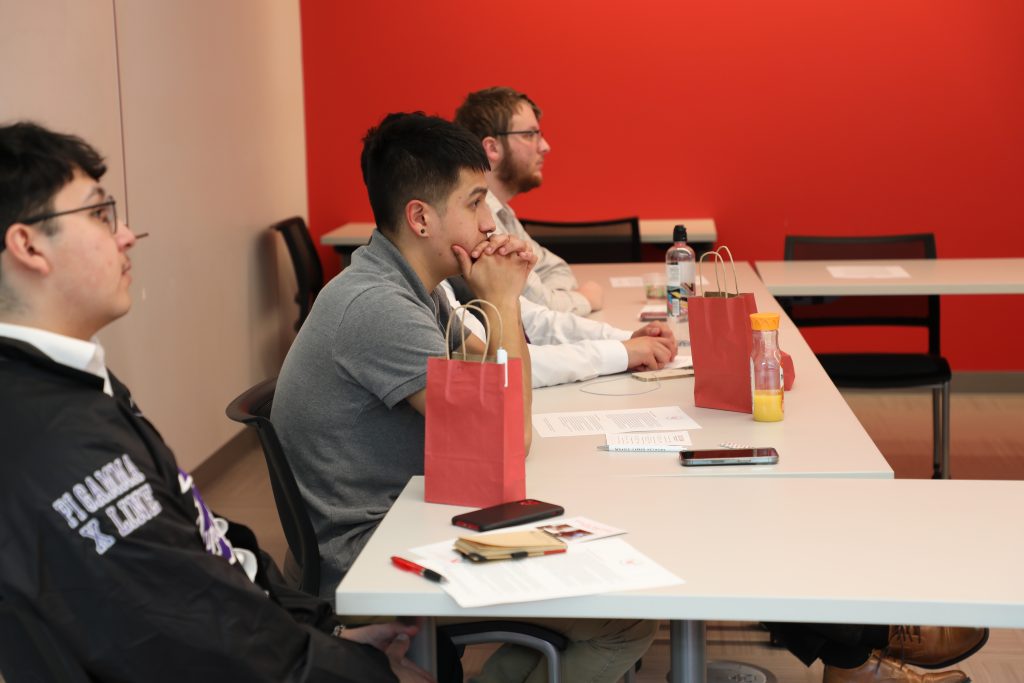 Students at a table talking in one of the PUB's conference rooms