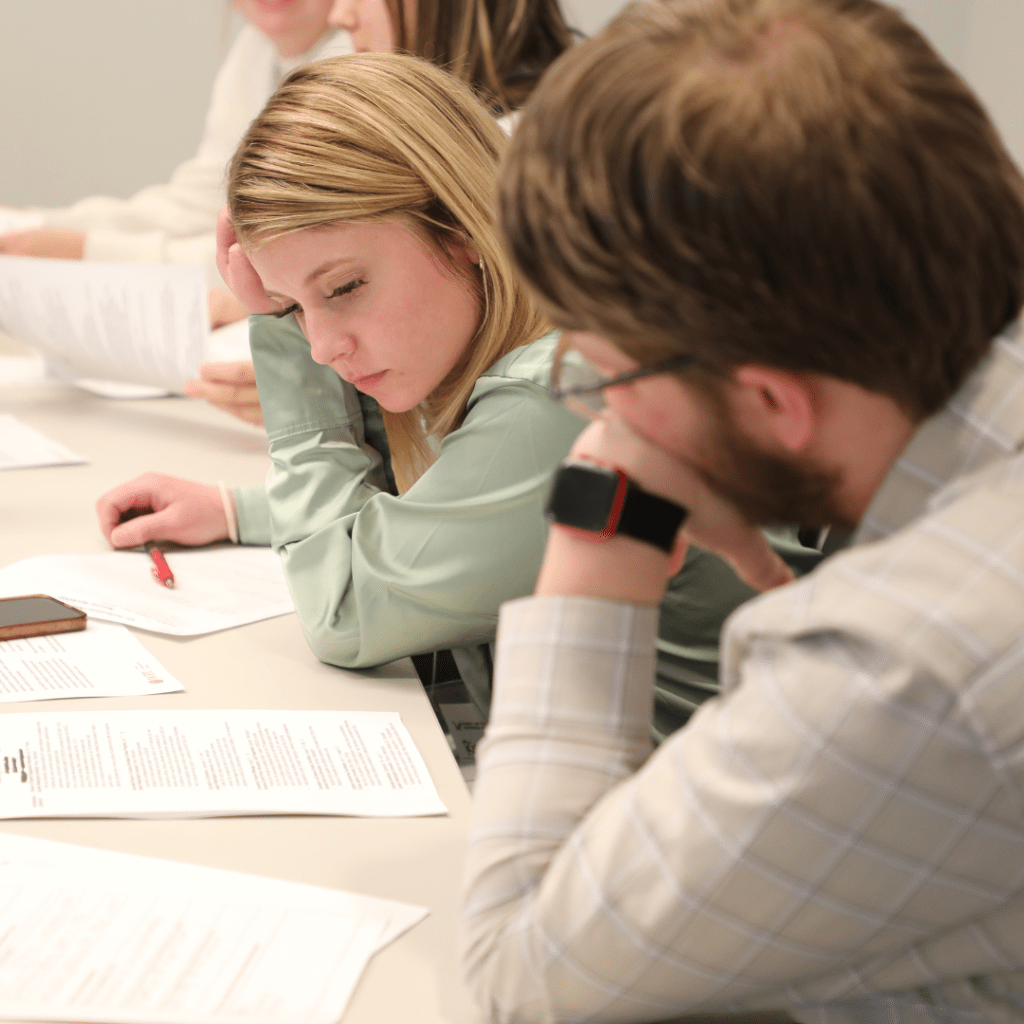 Two students at a table working together on a document.