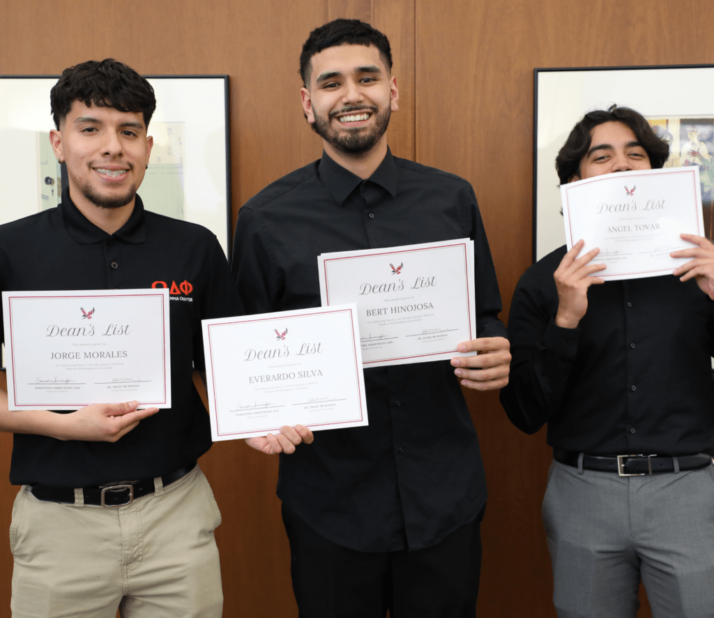 Photo of three men holding certificates