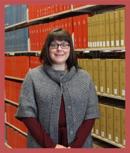 photo of samantha mccann in front of bookshelves